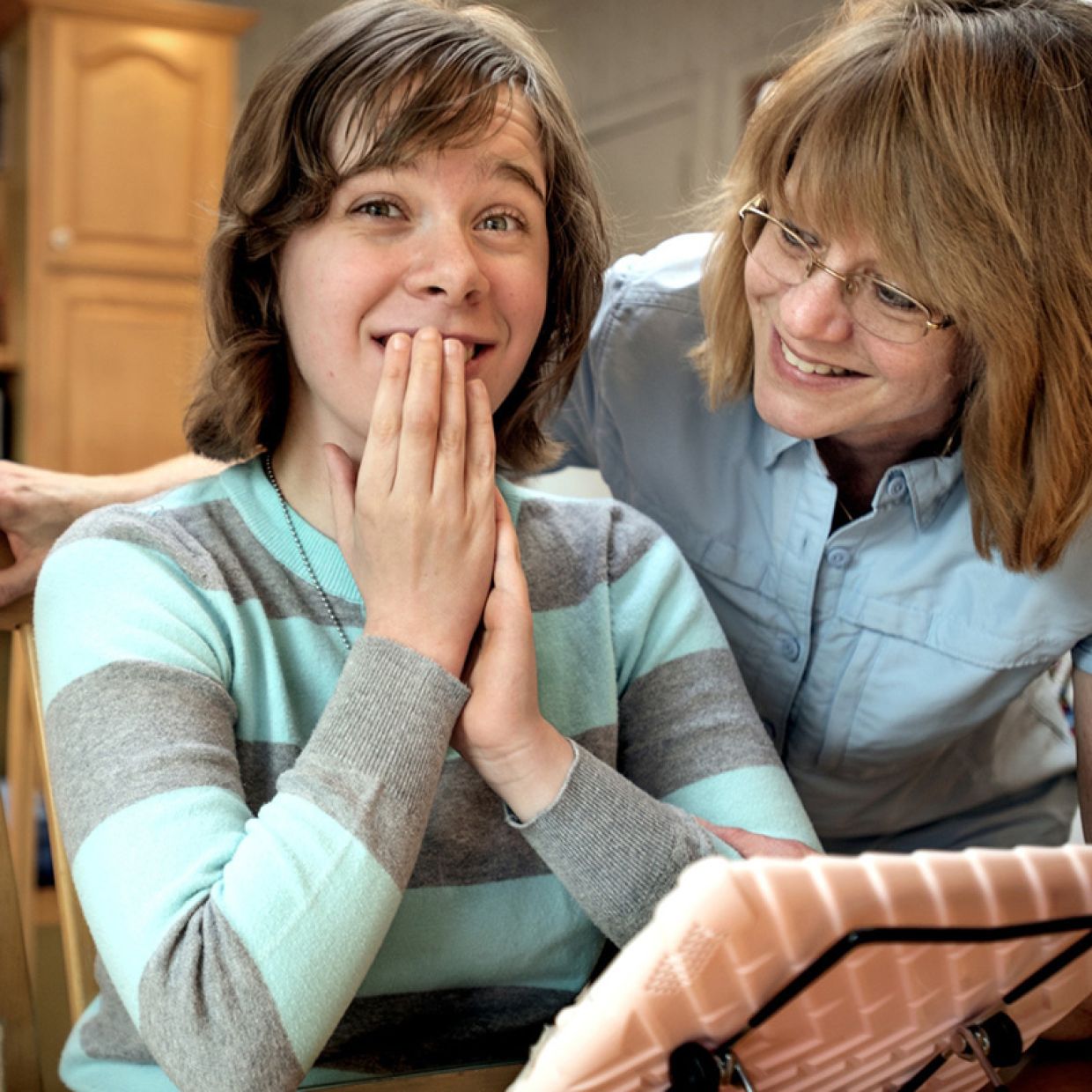 Woman smiling behind another woman smiling